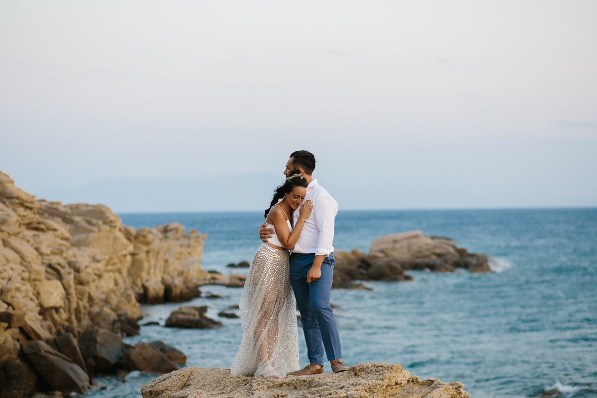 Destination Wedding Videographer & photographer in Mykonos. The couple embraced by the sea