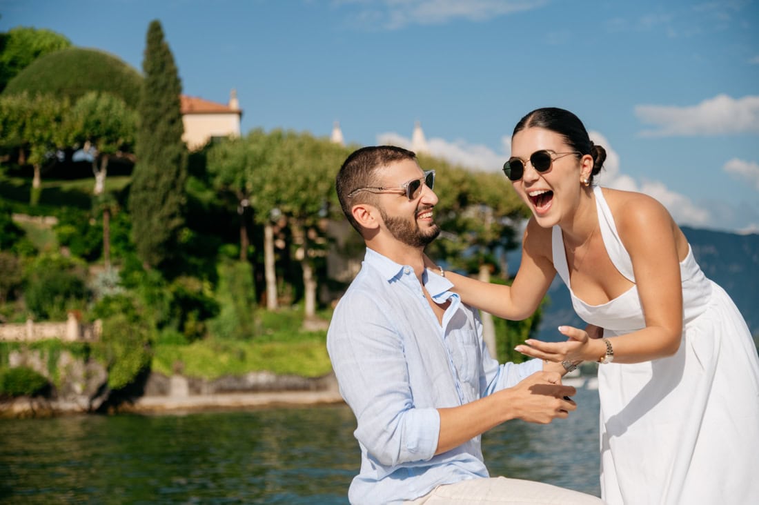 Surprise engagement proposal moment on the bow of a wooden Venetian boat