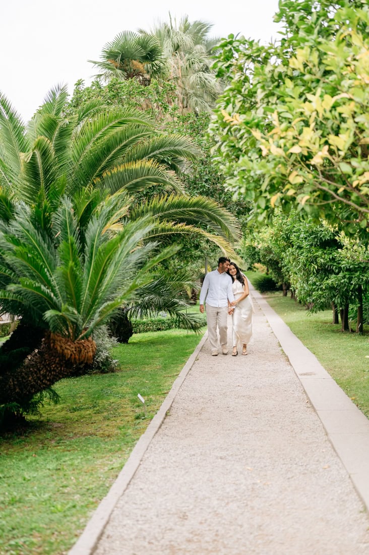 Couple holding hands along the lakefront promenade at Villa Cipressi Varenna