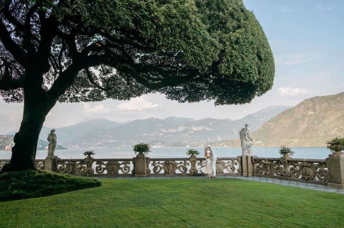 Couple photoshoot after proposal under the giant holm oak Villa del Balbianello